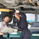 young-mechanics-working-garage